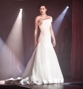Glamorous drop wais, one shoulder organza gown with dramatic satin trim now at Pink Confetti